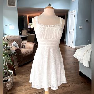 Small, White dress. Sleeveless and flowy.